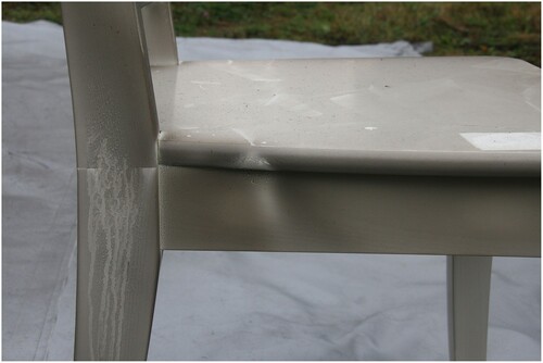 Figure 6. Example of damage after the fire test: soot on painted wooden chair. Minimal covering with gaps on the side allowed soot to get inside.