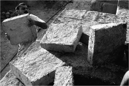 Figure 21. Baran Kerim Ecer stacking bricks to be used for capping the monument.