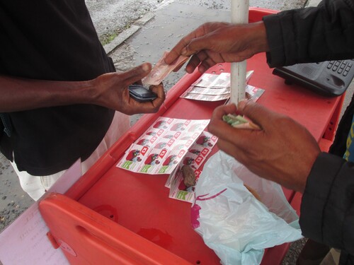 Figure 3 Street vendor selling scratch or ‘flex’ cards, Goroka, 2015. Photo by W. Bai Magea.