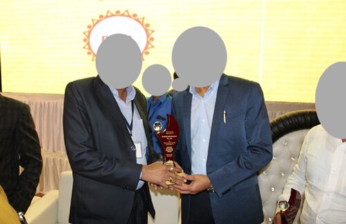 Figure 2. A property dealer is giving a memento to Srivastava (right) from INFINITY. Source: The picture is from the official websites of the real estate companies.