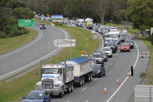 Figure 1. Vehicles waiting to pass through the Queensland/NSW border checkpoint, July 2020. Photo credit: Murray Waite and State Library of Queensland. Licensed under Creative Commons CC-BY-NC. Available at https://collections.slq.qld.gov.au/viewer/IE2047823.