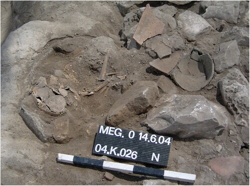 Figure 22 Skeletal remains in articulation in Baulk N–O/11 (Locus 04/K/38) in Area K. Note that the initial exposure of the individual was under Locus 04/K/26 (courtesy of the Megiddo Expedition, previously unpublished photo).