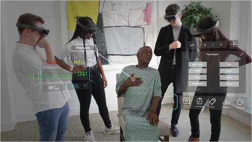 Figure 5. In the HoloPatient system, volumetric 3D video capture of a standardized patient sitting in a chair being assessed by a group of medical students. Students can view the patient and interact with the test results panel and real time vital signs through the use of the Microsoft HoloLens 2. Here the patient describes chest pain associated with myocardial infarction. Published with permission from GIGXR (www.gigxr.com/applications/holopatient)