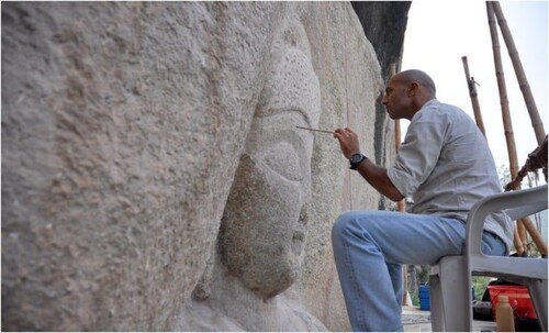 Figure 7. Conservator Fabio Colombo, who also worked on the massive Buddhas of Bamiyan, puts final touches on the Buddha’s face. Dozens of staff worked on the project, including 20 field workers, 6 restorers, and 2 3D-scanning experts. Source: ISMEO Italian Archaeological Mission – ACT.
