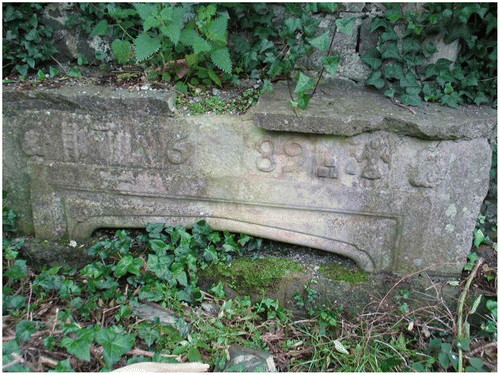 Figure 2. An arch stone dated 1689 from Bremore Castle, Balbriggan adjacent to St. Molaga’s church in North County Dublin, which appears to depict a monk on the right holding a skep with bees flying towards it.