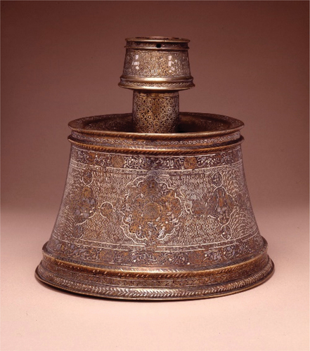 Figure 3. A brass Mosul School candlestick circa 1250, inlaid in silver and decorated with animal friezes and medallions, 25 x 27 cm, Courtesy the Trustees of the British Museum.