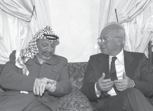 Former Israeli Prime Minister Yitzhak Rabin meets with then-PLO chairman Yasser Arafat in 1994. Rabin was assassinated in 1995 by a right-wing Israeli extremist who opposed negotiating with the Palestinians. GOVERNMENT PRESS OFFICE