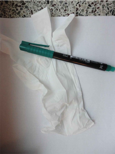 Figure 8. Piece of paper, a rubber glove and a pen