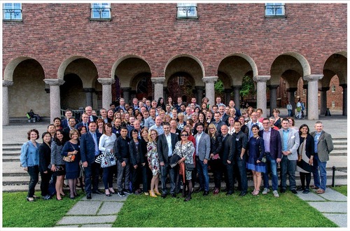 Figure 1. Group photograph of the 12th EOMW participants in front of the Stockholm City Hall during the social event, on 26th May 2017 (credit: Jack Mikrut).