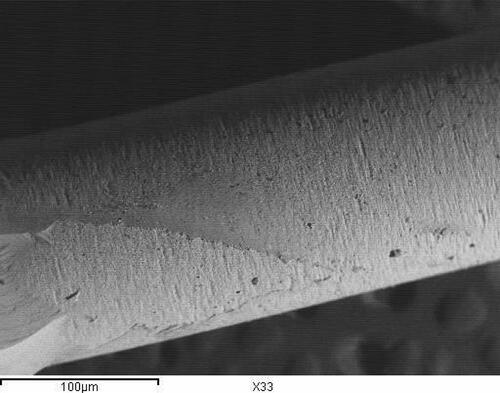 Figure 16 Representative SEM of sandblasting treated group attached to IPS empress core (original magnification 33) demonstrating adhesive/Cohesive type of failure.