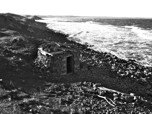 Figure 1. Sally Madge, Shelter on the north shore of Lindisfarne. Photo: Sally Madge, © Amy Madge and Lucy Madge.A simple drystone hut (now destroyed) Shelter was constructed in two iterations on a relatively unvisited part of the tidal island of Lindisfarne off the Northumberland coast, and represented in the exhibition through images, documents and related artefacts.
