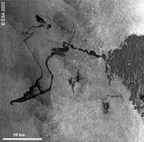 Figure 4.  Envisat (ASAR) image of oil pollution (shown in black) from the wreck of the tanker Prestige off the Spanish coast in November, 2002. (courtesy ESA)