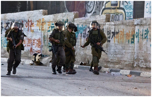 Figure 2. Two soldiers of an IDF patrol extracting their stun grenades.