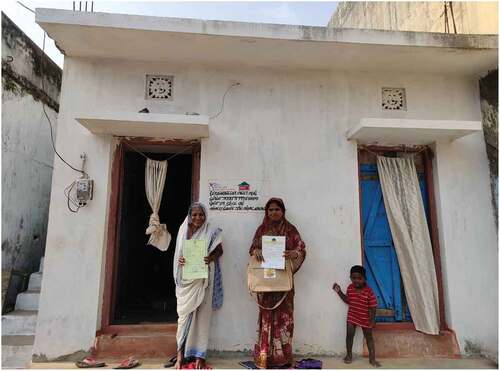 Figure 1. Residents of Harijan Sahi with their land rights certificates (LRCs), Gopalpur. Majority of the Harijan Sahi inhabitants had pucca houses prior to LRCs.