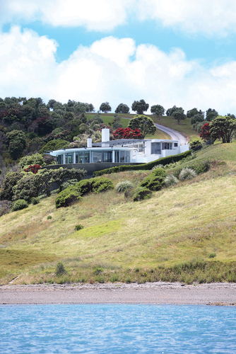 Figure 1. (b) is a large bach or holiday house as seen from the sea. An example of the now increasingly common large Waiheke Island house.Credits: The credit for the figure is Stuff Limited.