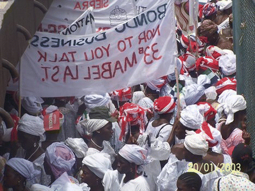Figure 2. Sowei council members during a demonstration carrying banners written in Krio.