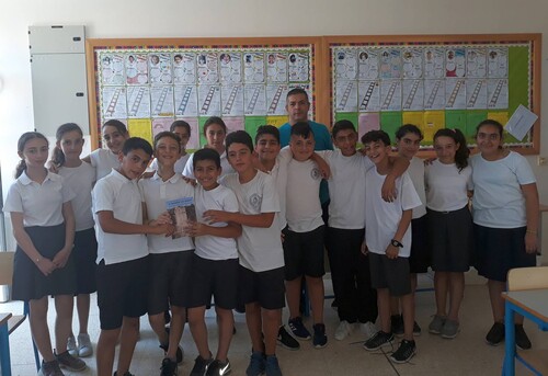 Figure 5. Asinou village researchers with their current Grade 6 teacher Mr. Kyriacos Papasolomontos presenting the book, The Settlement of Asinou: Tracing our Cultural Heritage. Photograph: Georgia Mylourdou.