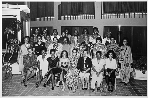 Figure 1. 1988 Nassau Bahamas, Essence Writers’ Retreat. This item is reproduced by permission of the Huntington Library, San Marino, California, OEB 7279. Note that this image was featured prominently in the exhibition; however, the names of these Black women writers were not listed in the exhibition.Seated (from left) Dr. Julianne Malveaux, Betty Winston Baye, Stephanie Stokes Oliver, Sonia Sanchez, Thulani Davis, Ntozake Shange, Valerie Wilson Wesley, Bebe Moore Campbell. Second row, from left Toni Cade Bambara, Elsie Washington, Barbara Smith, Marlene NorbeSe Philip, Bonnie Allen, Sherley Anne Williams, Cheryll Y. Greene, Ayesha Grice, Phyl Garland, Ivy Young, Elaine Brown. Last row, from left Susan L. Taylor, Lena G. Sherrod, Renita Weems, Jean Wiley, Audrey Edwards, Jill Nelson, Vertamae Grosvenor, Octavia Butler, & Lucille Clifton.