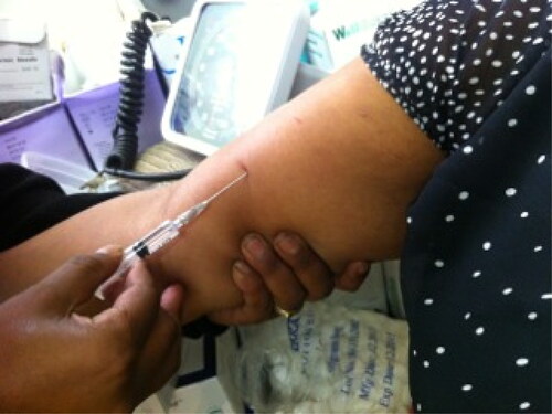 Image 2. A nurse injects a patient with anaesthetic to numb her arm before Implanon insertion.