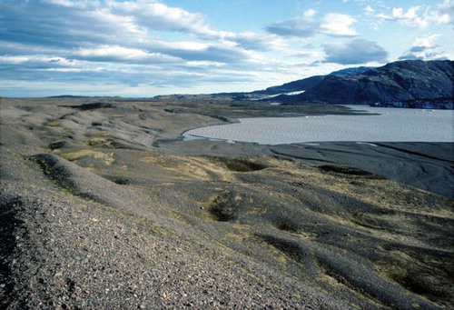 Figure 6. View across the push moraines on the terraced and pitted ice-contact face of the outwash head at Heinabergsjökull. These features document contemporaneous kame terrace formation, snout melt-out and push moraine construction.