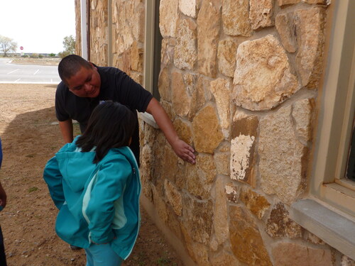 Figure 5. During the “Rock House Activity,” Darryl Reano indicates different features of rocks that might be interesting for the participants to observe.