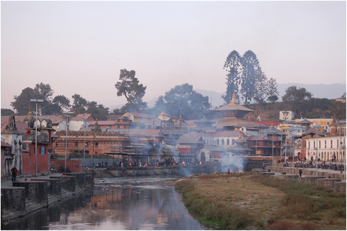 Figure 1. The traditional Pashupati crematorium area with the Pashupatinath temple in the background to the right side. Photo by author, 2017.