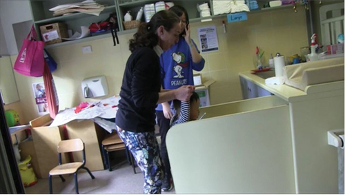 Figure 2. The nappy change space (Peta holding Victor’s hands to climb the steps while Ellen observes).