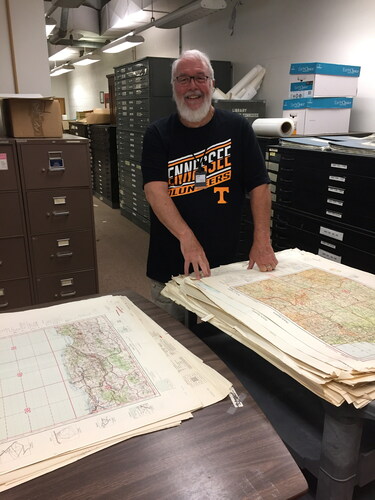 Figure 1. Jeff French, UT Map Collection Supervisor, stands next to a stack of maps (organized by size) ready to be loaded onto a pallet in the basement of Hoskins Library. (Photo courtesy of Greg March.)