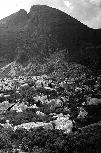Figure 7 The Beinn Alligin rock avalanche, Torridon. Roughly nine million tonnes of rock failed along a 42° failure plane bounded by converging fault scarps and travelled 1.25 km down the floor of a corrie. Cosmogenic isotope dating of runout boulders places the date of failure at 4.0 ± 0.3 kyr, approximately 7500 years after deglaciation