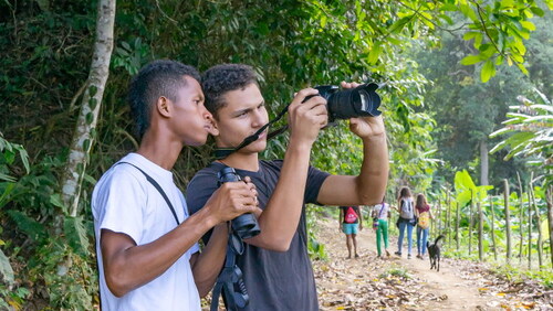 Image 1. Two of the participants of the program during a workshop. 3628 × 2042 mm (28 × 28 DPI).