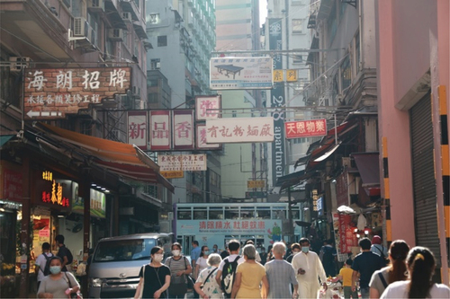 Masked Hong Kongers in Wan Chai District during the pandemic in 2020. Source credit: Photo by Alison Pang on Unsplash.