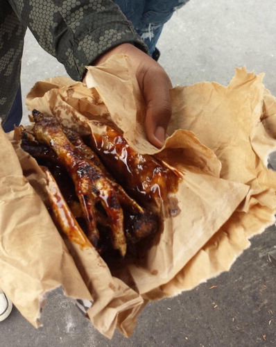 Plate 2. Braaied (BBQ) chicken feet (R0.50 per foot) served in scrap paper wrapping from a street barbeque; Delft Cape Town.