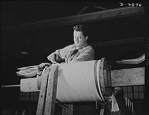 Figure 5.  Worker winding an asbestos insulated low-volt coil (1942). Photographer: Alfred T. Palmer. Library of Congress Prints & Photographs Division.