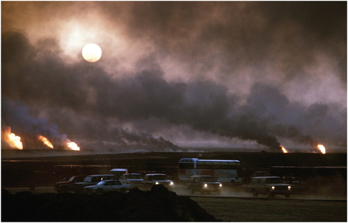 Figure 6. The smoke from oil well fires forces Kuwait drivers to use their headlights during daylight hours on April 22, 1991. Source: Everett Collection/Shutterstock.