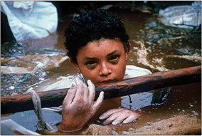 FIGURE 1: A 13-year-old girl trapped in the rubble of the Ruiz eruption in 1985. Photo: Frank Fournier. Used with permission of the photographer.