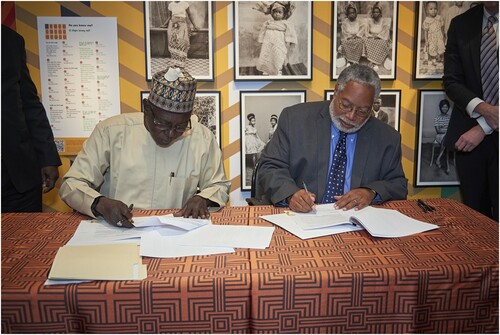 Fig. 8 Lonnie G. Bunch III, Secretary of the Smithsonian, and Professor Abba Tijani, Director General of the NCMM, sign the papers for transfer of ownership of the bronzes. Photograph by Brad Simpson, National Museum of African Art, Smithsonian Institution.