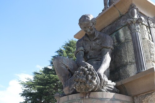 Figure 2. Male figure binding sheaf of wheat, southwest side George Evans monument. Photo courtesy of David Ambery.