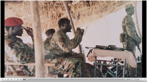 Figure 2 A still photograph of Dr Garang with SPLM fighters at an undisclosed location afield. It shows his political and military frontline role during pre-Independence struggles. (Screen freeze-frame from No Simple Way Home). Accessed from Afri Docs’ (@AfriDocs)—https://youtu.be/90m7gpKKnqU
