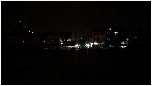 Figure 4. The Isan restaurant and a cluster of lit windows as seen from the field. The haunted house is on the far left.