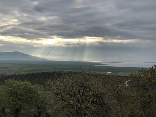 Figure 2. Mid-day sun peeking through cloud cover over Lake Marmara, March 2021. Photo courtesy of author.