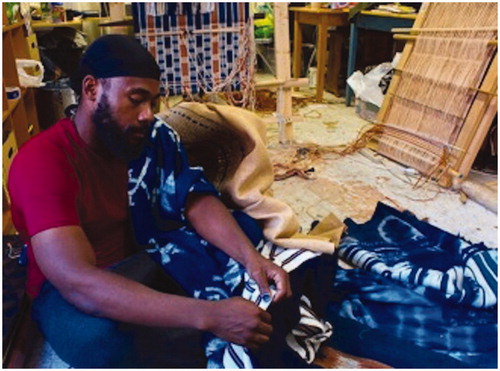 Figure 4. Stephen Hamilton working with fiber and textiles in his studio. “Each textile is made on the Nigerian upright loom using patterns and techniques employed by Yoruba, Igbo, Edo, Nupe, Tiv, and Ebira weavers. All yarn is hand-dyed using only natural dyes” (personal communication, June 25, 2019).