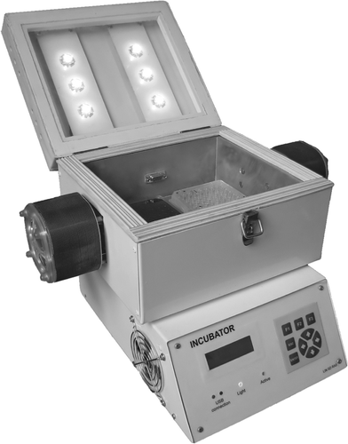 Fig. 1. The incubator with lid open and two microtitre plates in place but without the diode matrix attached.