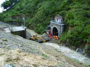 Figure 2. Dam break by Pisciotta landslide local reactivation that caused the interruption of the rail traffic in the odd track of the Salerno-Reggio Calabria railway and the obstruction of the stream. The catastrophic event occurred during the period December 2008–January 2009. In the picture, you can see the railway tunnel and the rescue personnel at work (belonging to both the Italian State Railways and Civil Protection Department).