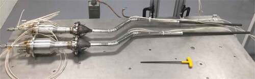 Fig. 3. Two KRUSTY heat pipes attached to two Stirling thermal simulators that completed thermal performance testing and are in the middle of multilayer insulation fabrication.