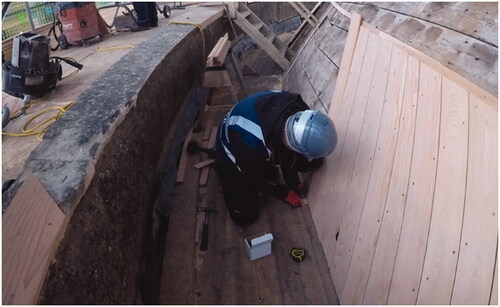 Figure 2. The carpenters scribe the cladding before cutting the bevel.