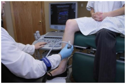 Figure 16 Scanning the lower extremity with patient seated on the exam table.