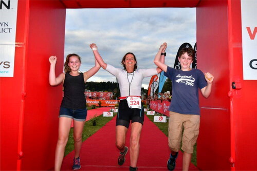 Figure 11. Lucy crossing the finish line at Challenge Wanaka with her children, securing a bronze medal in the 40-50 year age category and a place in the European Championships.Source: Authors.