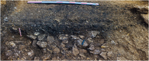 Figure 10. Pit 5, Trench 4, with stone base and charcoal preservation (photo by Bernorio-IMBEAC Team).