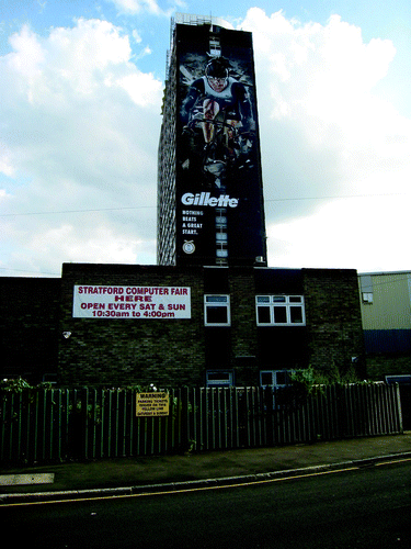 Figure 2 Carpenters and Dockland Centre in foreground, with corporate Olympics branding in background, July 2012