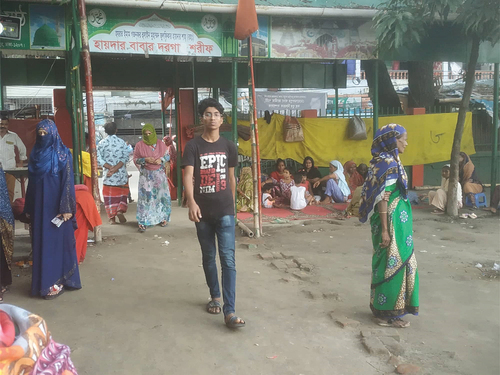 Image 2. Devotees seated inside the small shrine complex Photo Credit: Surveyor.